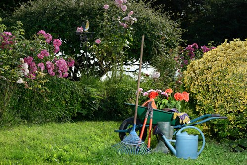 Landscaping team carrying out safe garden clearance with protective measures in place